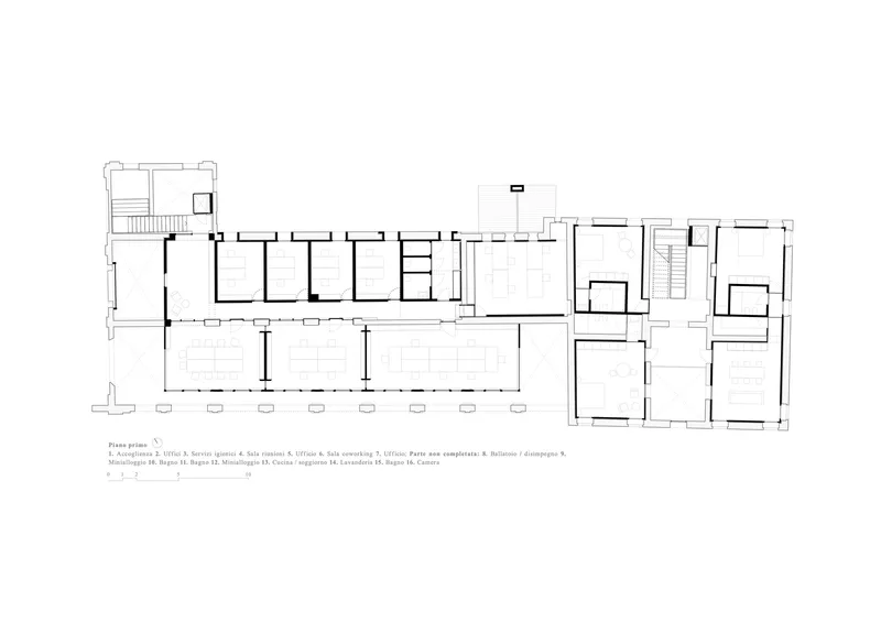 First floor plan drawing showing a long corridor with repeated rooms and open circulation spaces