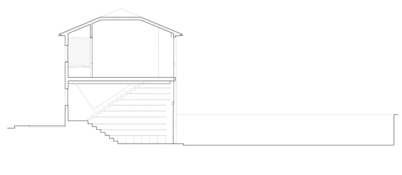 Section drawing revealing a two-story gabled volume with internal stair descending to grade