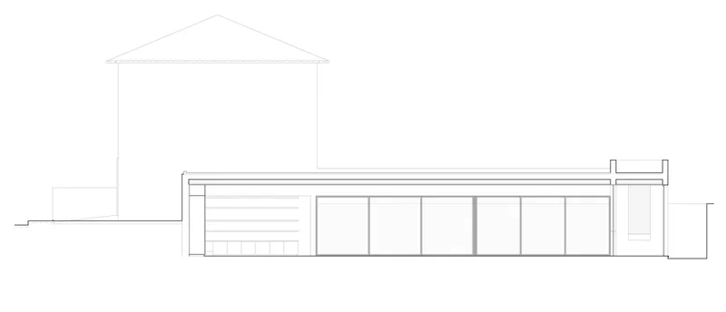 Elevation drawing showing a low horizontal wing with glazed openings beside a pitched roof structure
