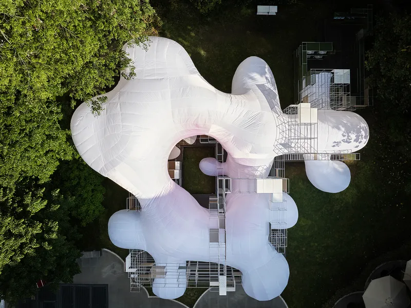 Aerial view of the white inflated membrane roof with bulbous lobes nestled among surrounding trees and buildings