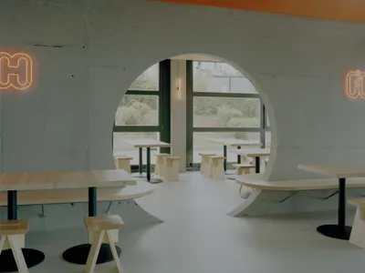 Noue Studio Organizes a Swiss Restaurant Around a Single Concrete Wall