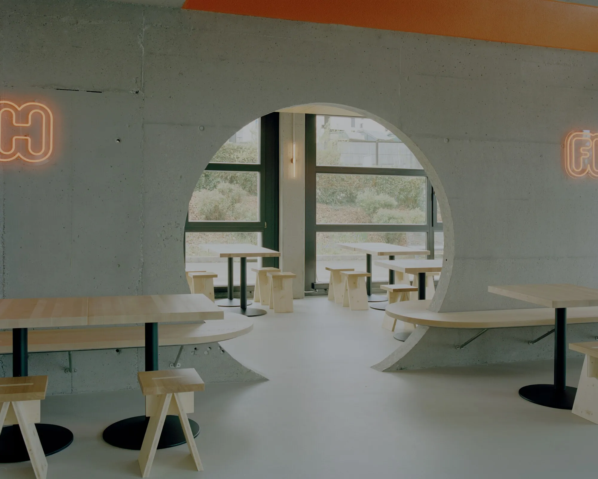 Noue Studio Organizes a Swiss Restaurant Around a Single Concrete Wall