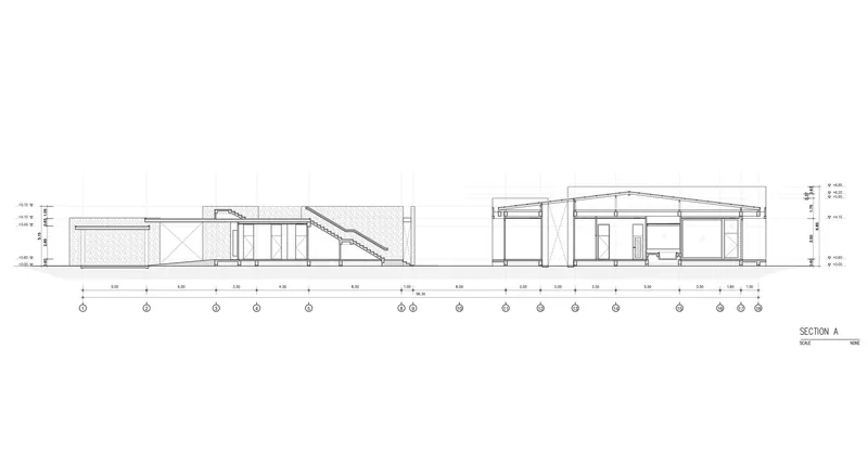 Section drawing revealing a sloped roof structure with visible rafters connecting two distinct building volumes