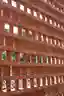 The image showcases a brickwork screen facade, featuring an openwork pattern that allows light and a