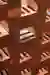 This architectural image showcases a stack of red bricks, highlighting their texture and pattern. Th