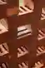 This architectural image showcases a stack of red bricks, highlighting their texture and pattern. Th