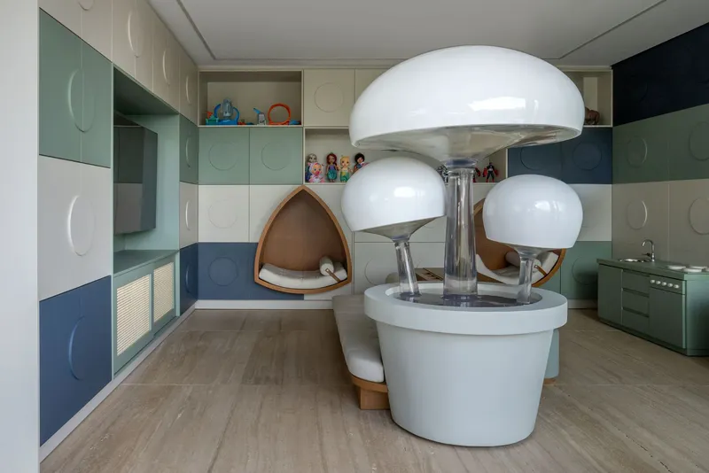 Interior room with multi-toned circular panel cabinetry and sculptural white pod seating with timber inserts