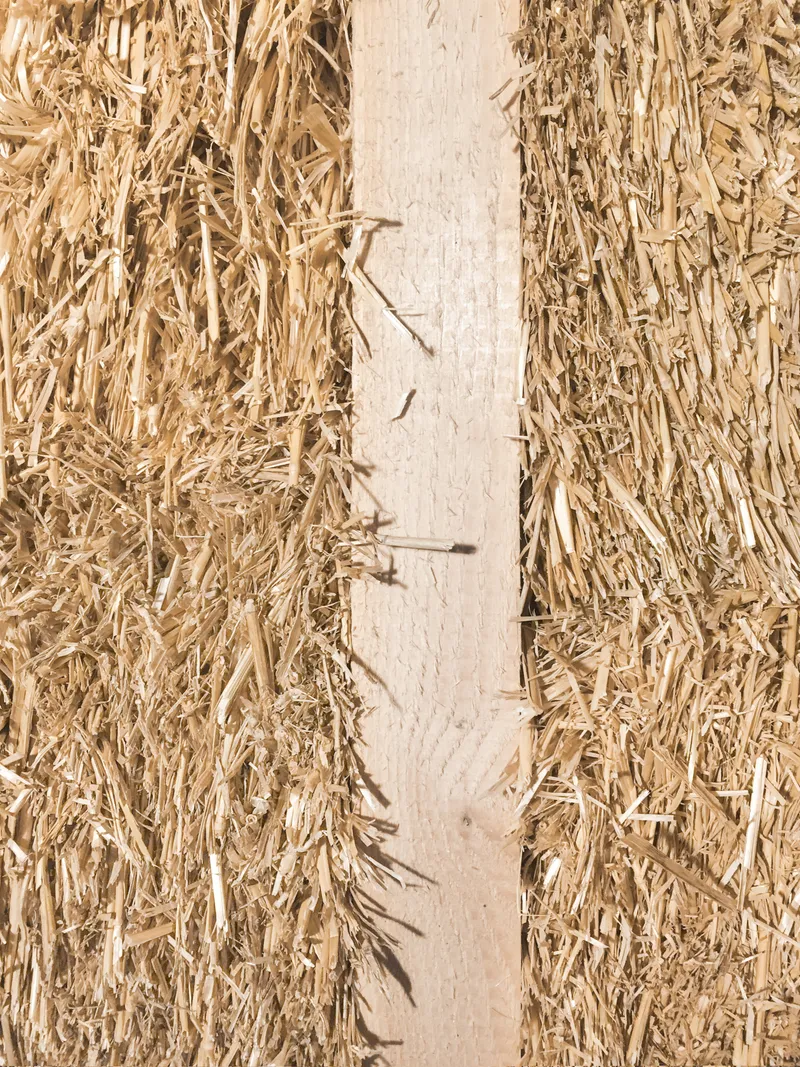 Detail of straw insulation panels meeting a vertical timber structural element