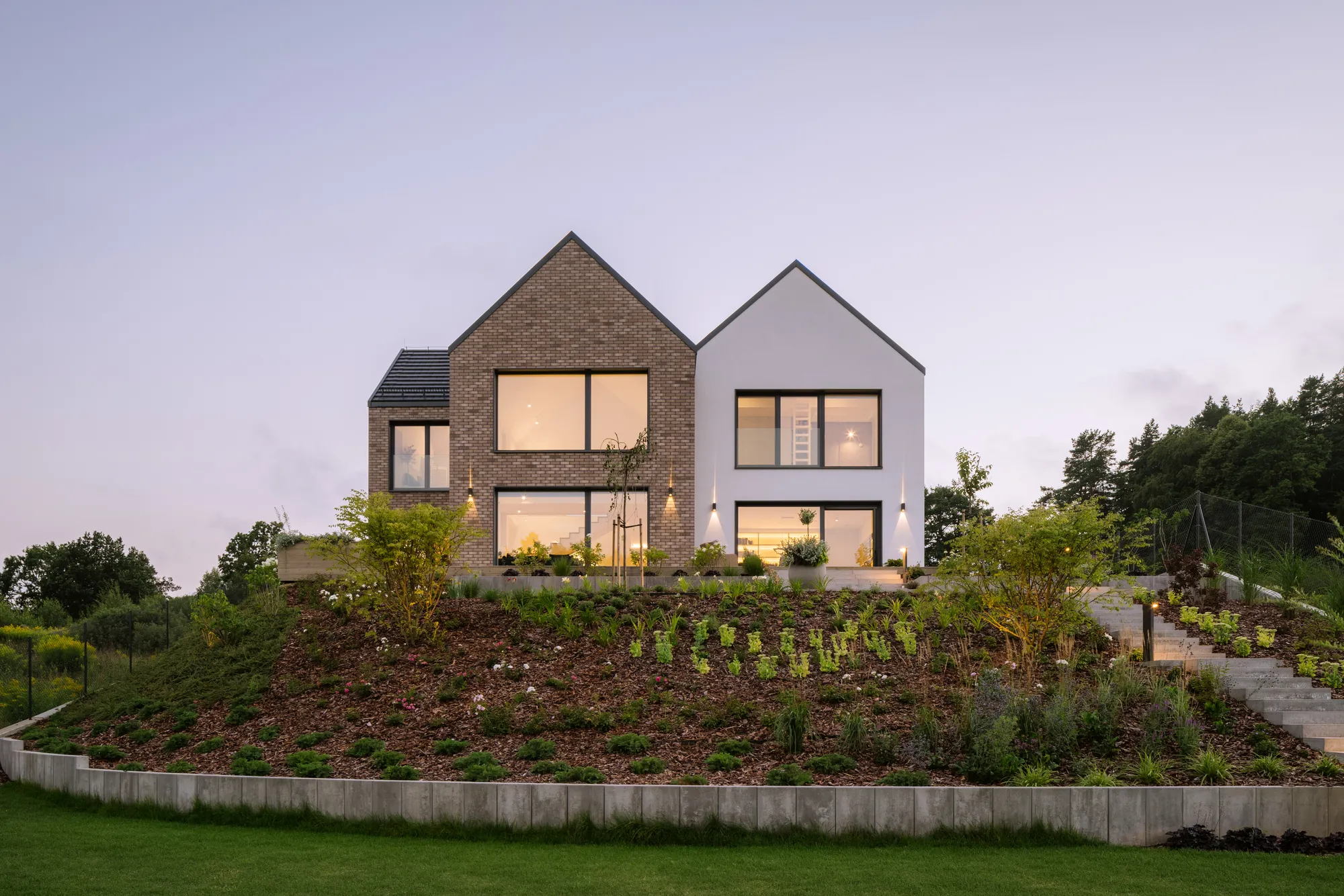 bkm group Splits a Hilltop Home into Stacked Gables Overlooking a Polish Landscape Park