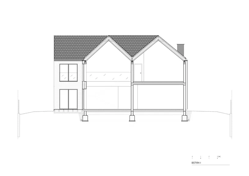 Section drawing showing two gabled volumes with double-height spaces and sloped terrain below