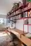 COTA760 Wraps a São Paulo Apartment in a Continuous Red Steel Bookshelf
