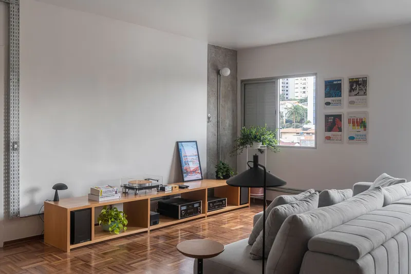 Living area with low timber credenza and exposed concrete column beside window