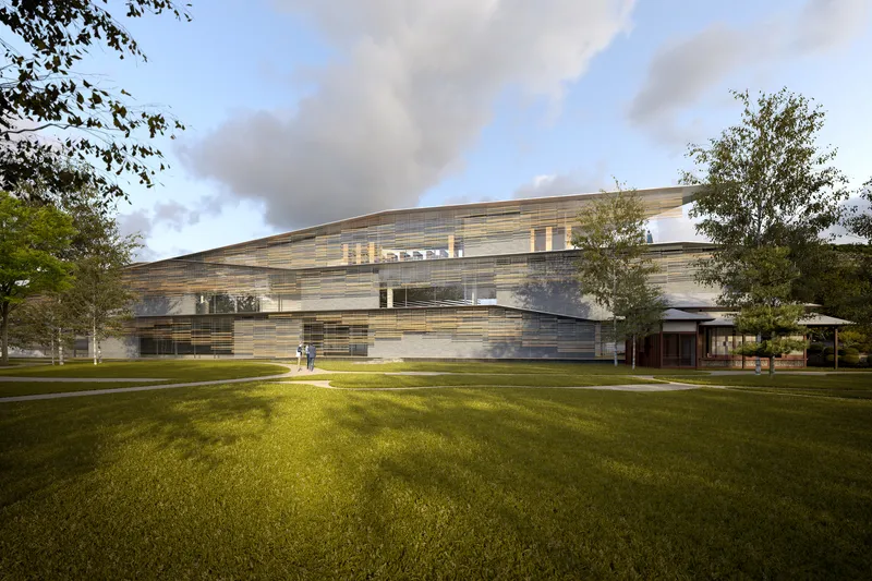 Lawn view of the layered horizontal facade under late afternoon light and partly cloudy skies