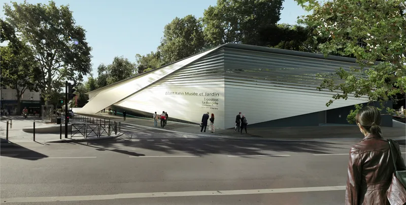 Street view of the angular white metal facade lifting toward the sky with pedestrians and trees