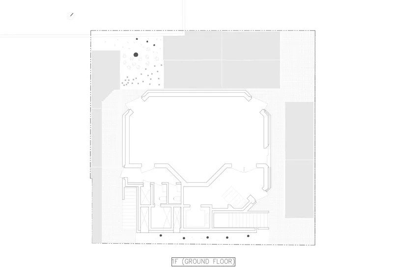 Ground floor plan drawing showing a large open volume with service rooms and a stair along one edge
