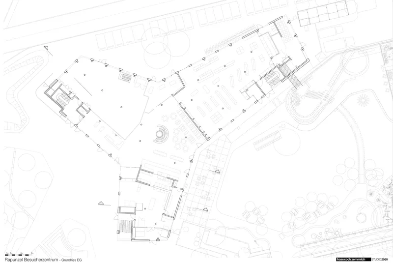 Site plan drawing showing irregular building footprints with a spiral stair and surrounding landscape elements