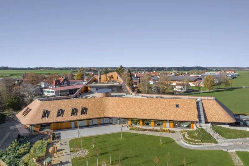 Aerial view of the thatched roofs with dormer windows set within a rural village landscape