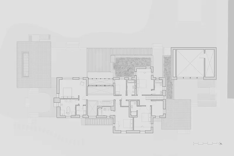 Floor plan drawing showing interconnected rectangular volumes with courtyards and patterned stone areas