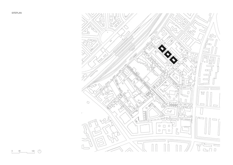 Site plan drawing showing three rectangular volumes adjacent to diagonal railway tracks and surrounding urban blocks