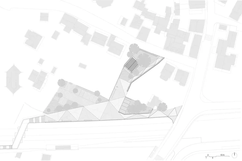 Site plan drawing showing an angular building and landscape among surrounding trees and neighborhood