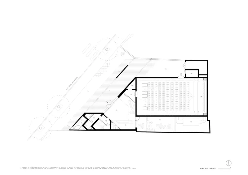 Floor plan drawing depicting a main assembly hall with rows of seating and angled volumes at the corner