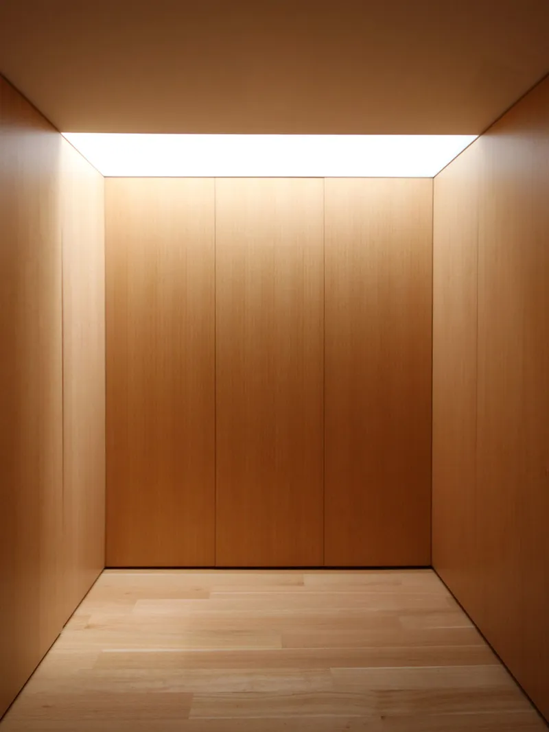 Timber-lined corridor with continuous skylight running the length of the ceiling