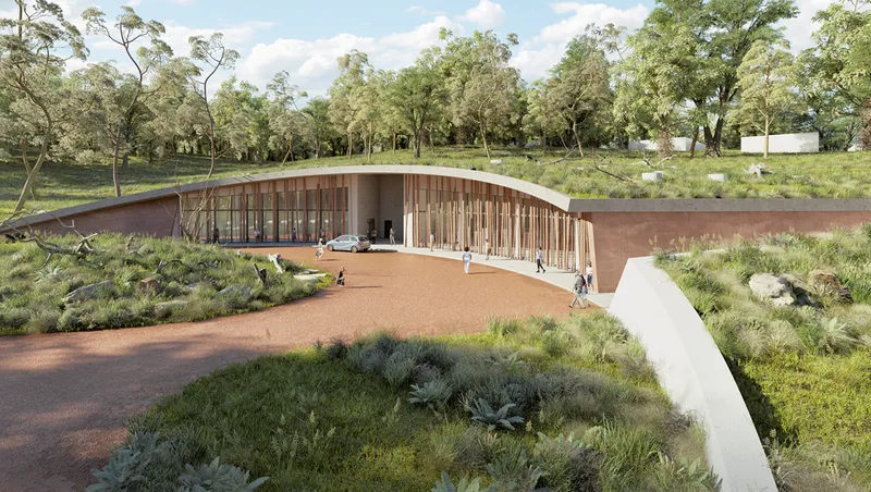 The visitor entrance combines biophilic architecture with natural materials and open landscape integration.