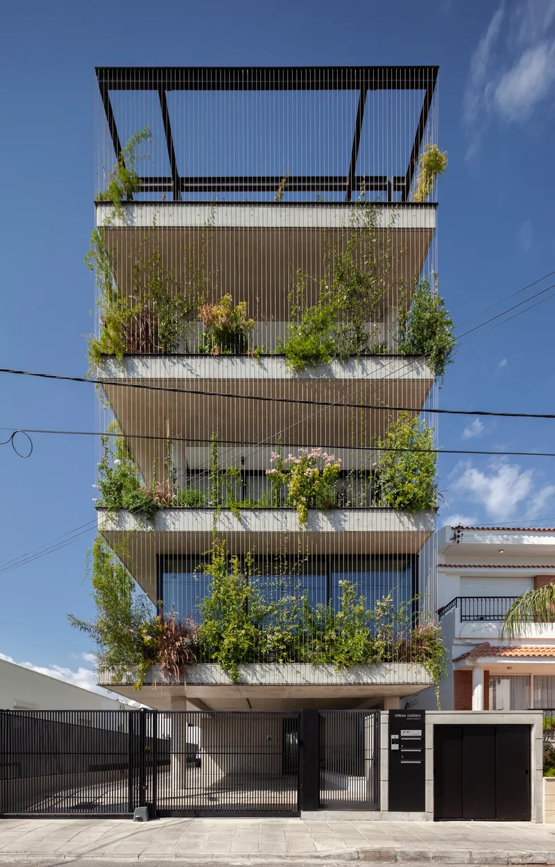 Facade detail of the vertical louvered screens with greenery spilling from each balcony level