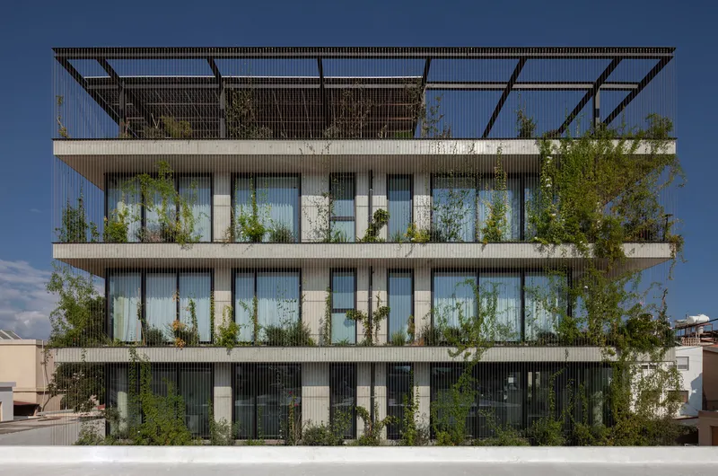 Side elevation revealing the full-height glazing and planted balconies behind vertical screening elements