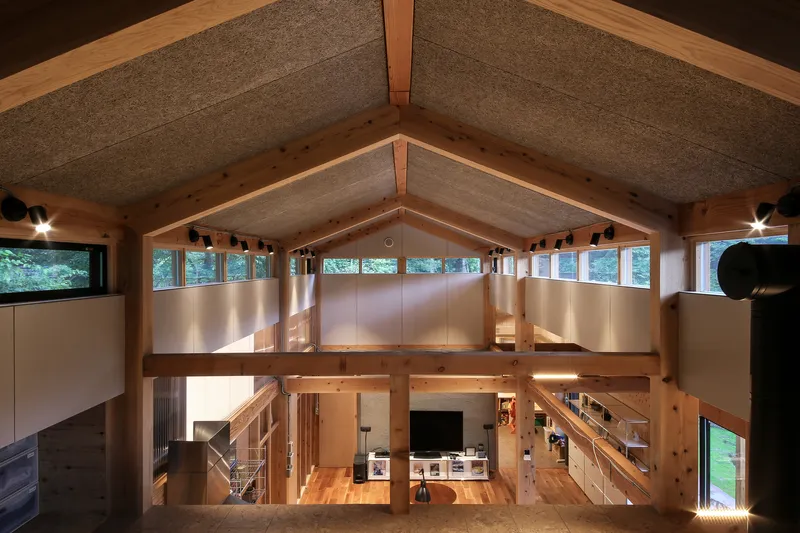 Interior view from the mezzanine showing the gabled timber ceiling with hempcrete panels and clerestory windows