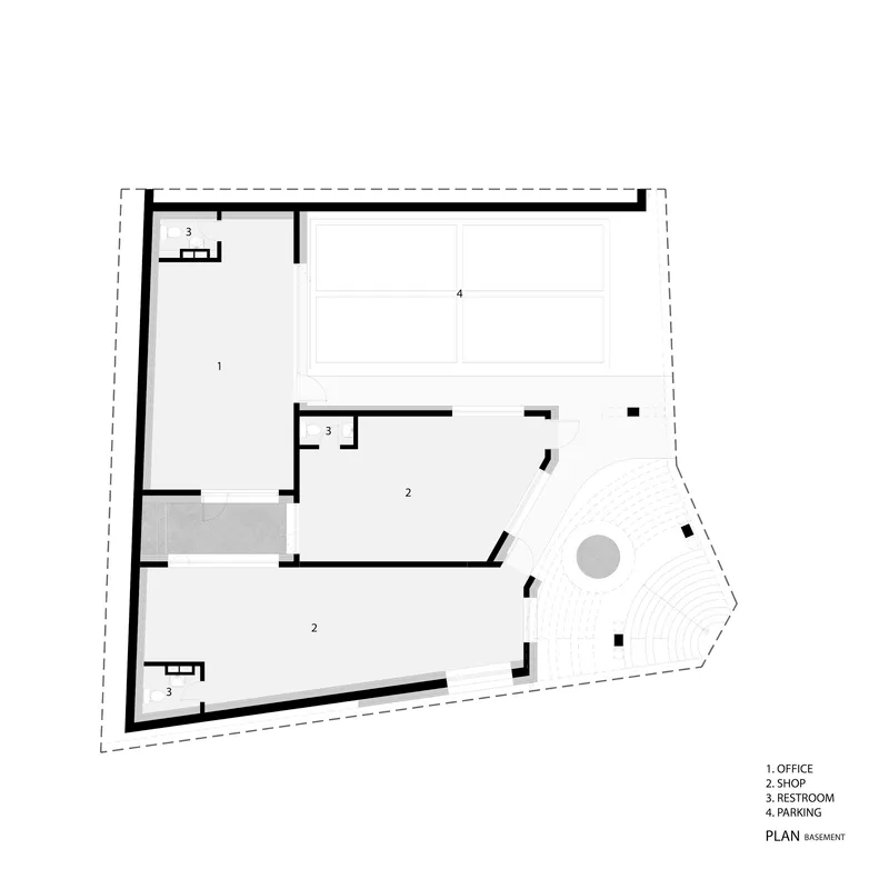 Basement level floor plan drawing showing office, shop spaces, restrooms, and curved amphitheater seating