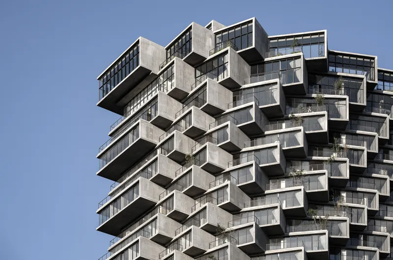 Close-up of the cantilevered concrete balconies and floor plates stacked in alternating layers