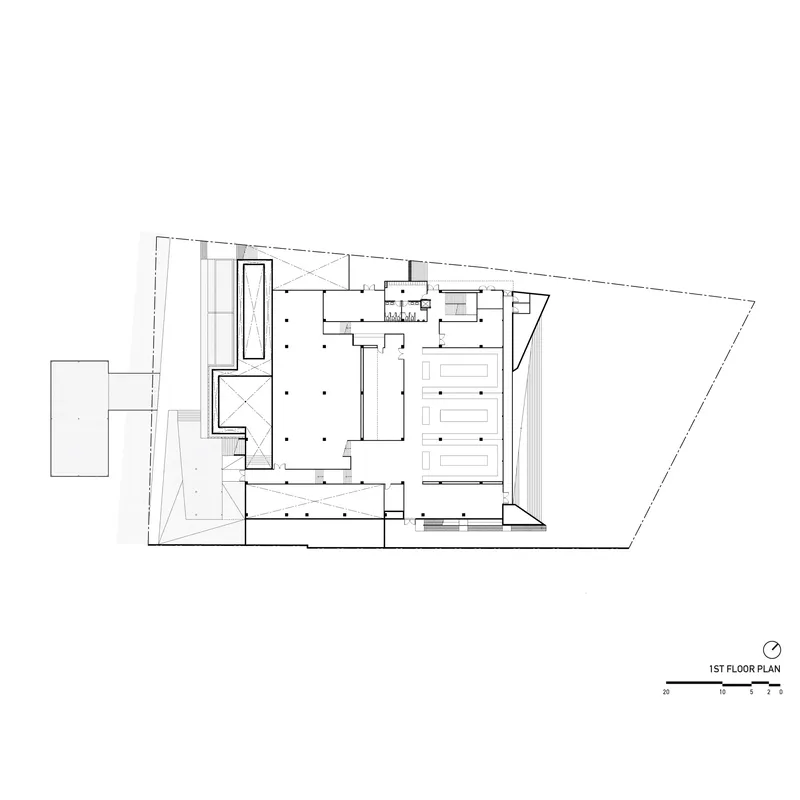 First floor plan drawing showing trapezoid site with central courtyard and perimeter support spaces