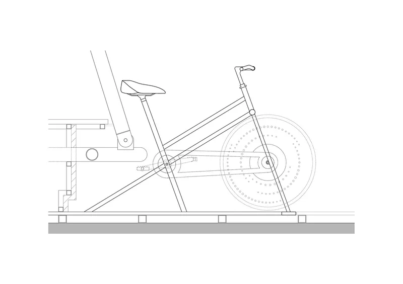 Section drawing detailing a stationary bicycle mounted on an angled frame with resistance mechanism