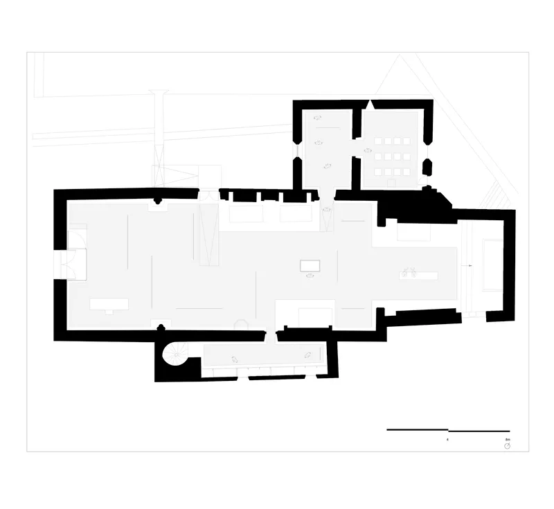 Floor plan drawing showing an irregular residential layout with multiple rooms and thick exterior walls