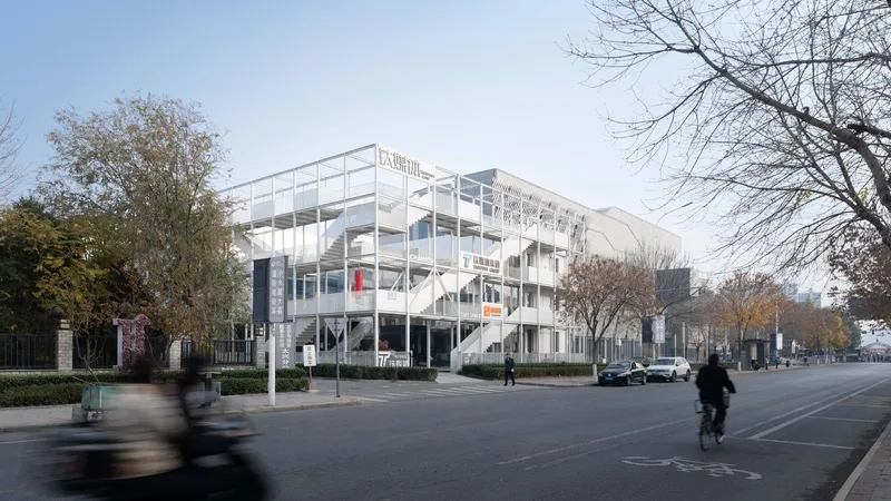 Street view of the white structural frame with cyclists and pedestrians passing in autumn