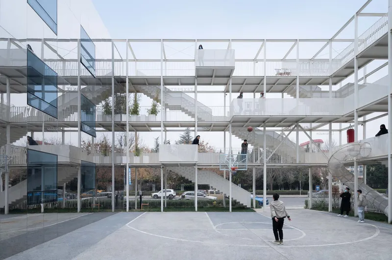 Central courtyard with exposed structural grid connecting multi-level residential units and circulation stairs