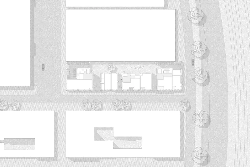 Site plan drawing showing building footprint with courtyard and row of street trees