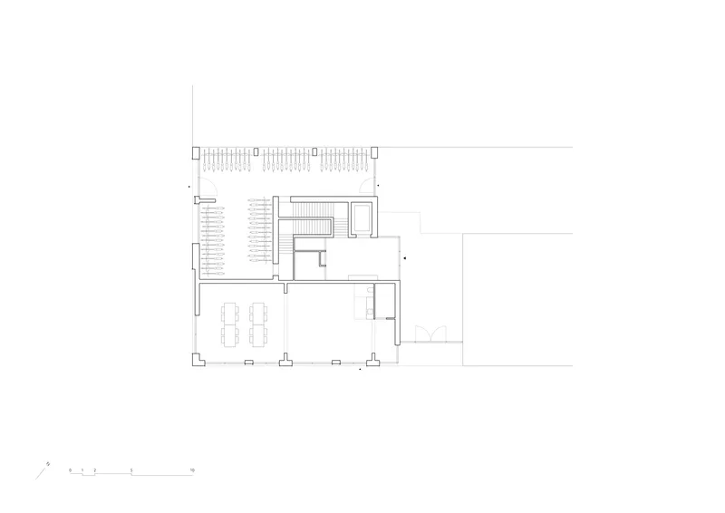 Ground floor plan drawing showing parking area, stairwell, and open dining space with terrace
