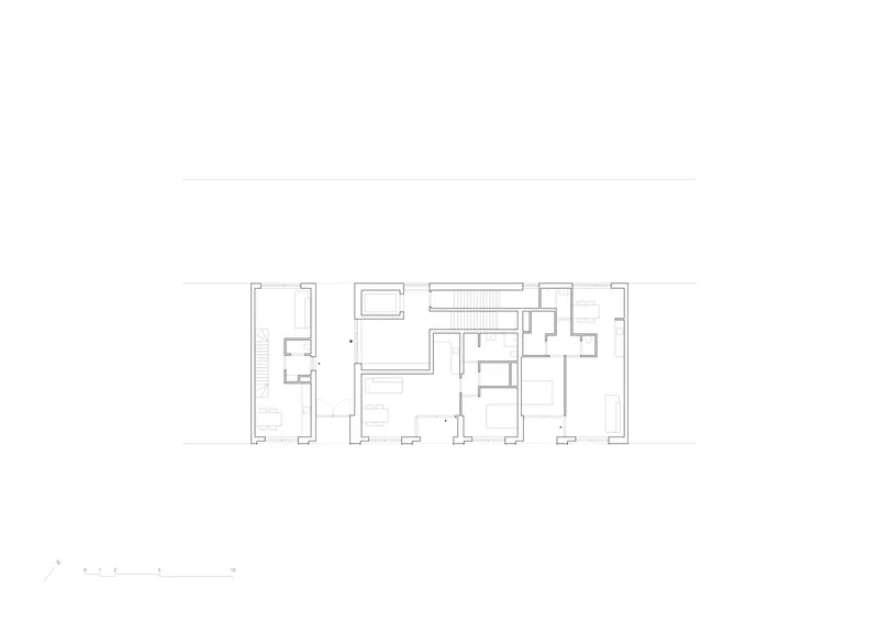 Floor plan drawing showing staggered residential units connected by a central circulation spine
