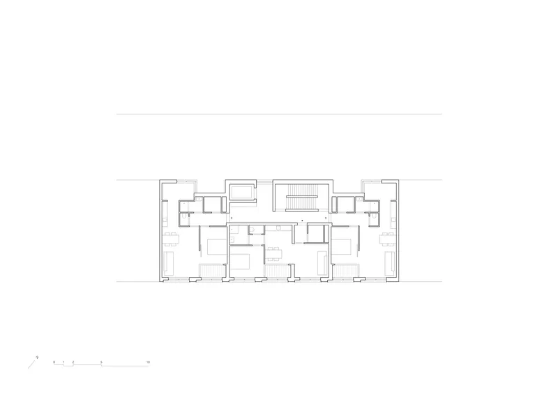 Upper floor plan drawing with symmetrical residential units flanking a central stair core