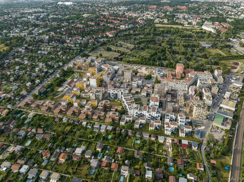 Aerial view of the mixed-use residential development surrounded by suburban neighborhoods and parkland
