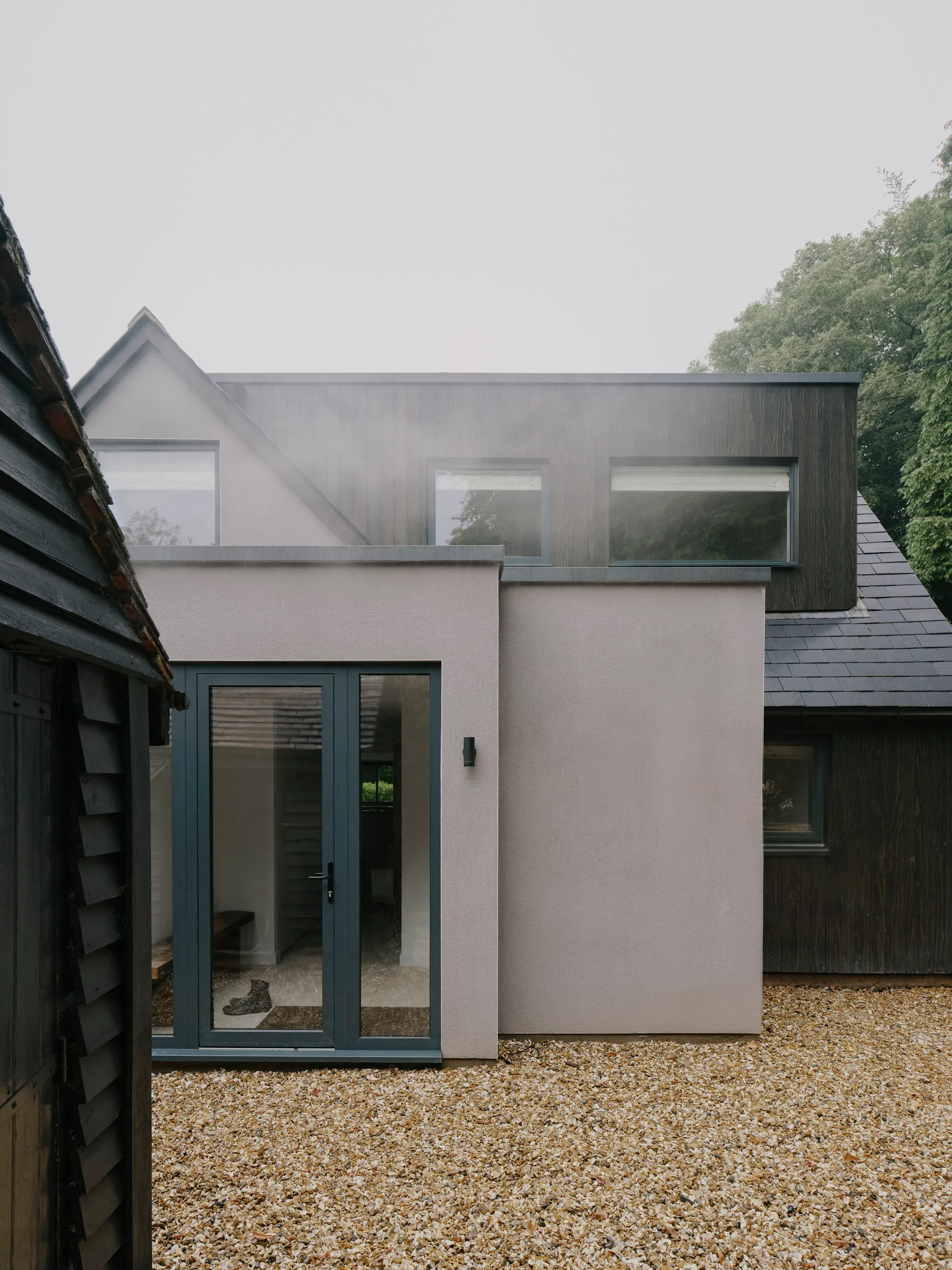 MiMStudios Wraps a 1968 Surrey Hills Home in Dark Timber and Permaculture Gardens