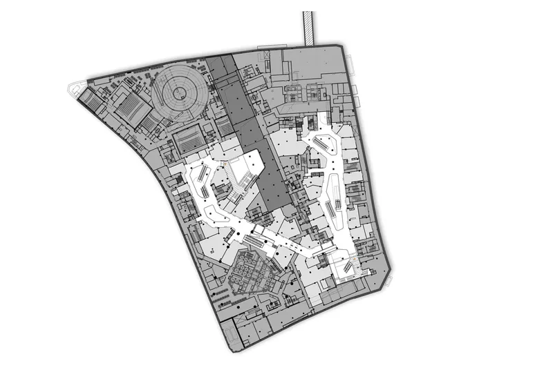 Floor plan drawing showing irregular polygonal footprint with central circulation spine and circular element