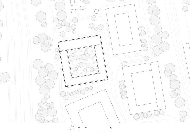 Site plan drawing showing four rectangular volumes arranged among existing trees and pathways