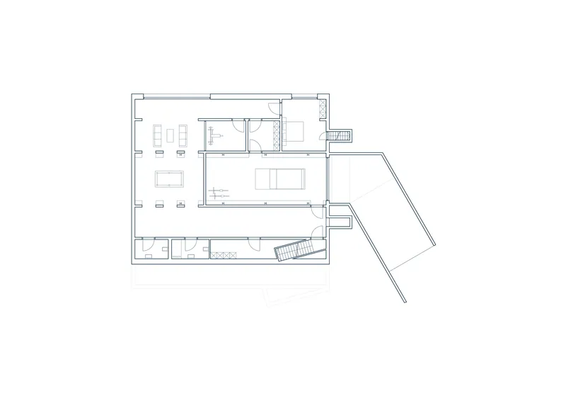 Floor plan drawing showing living spaces with angled wing and central circulation