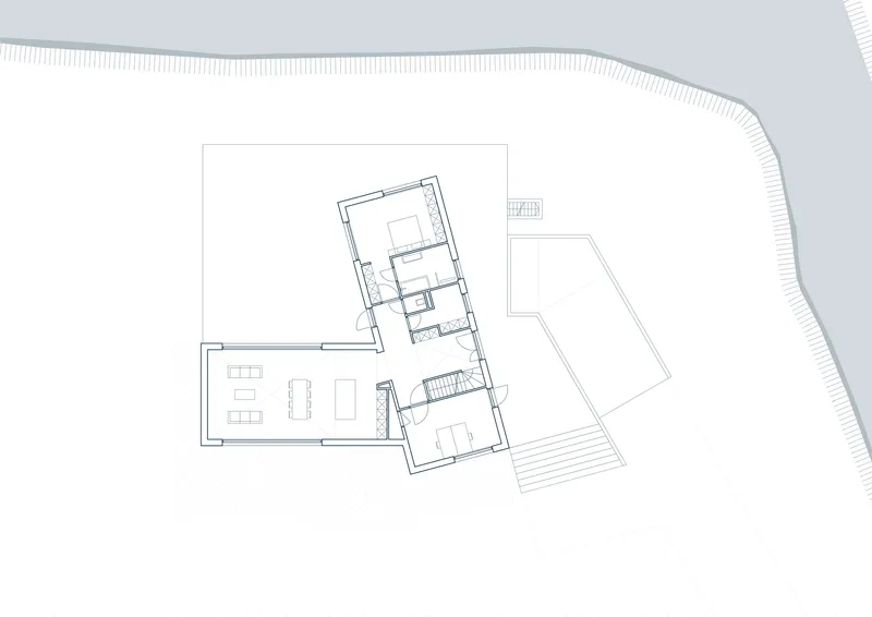 Floor plan drawing showing residence with angled volumes and adjacent curved topography
