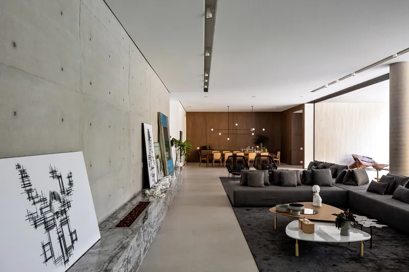 This architectural image showcases a modern interior with an open floor plan, seamlessly blending the living and dining areas. The design features a striking co