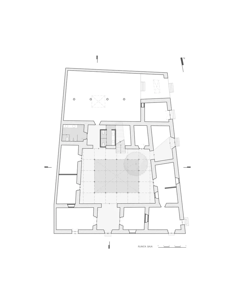 Ground floor plan drawing showing a large courtyard surrounded by perimeter rooms and a central stair