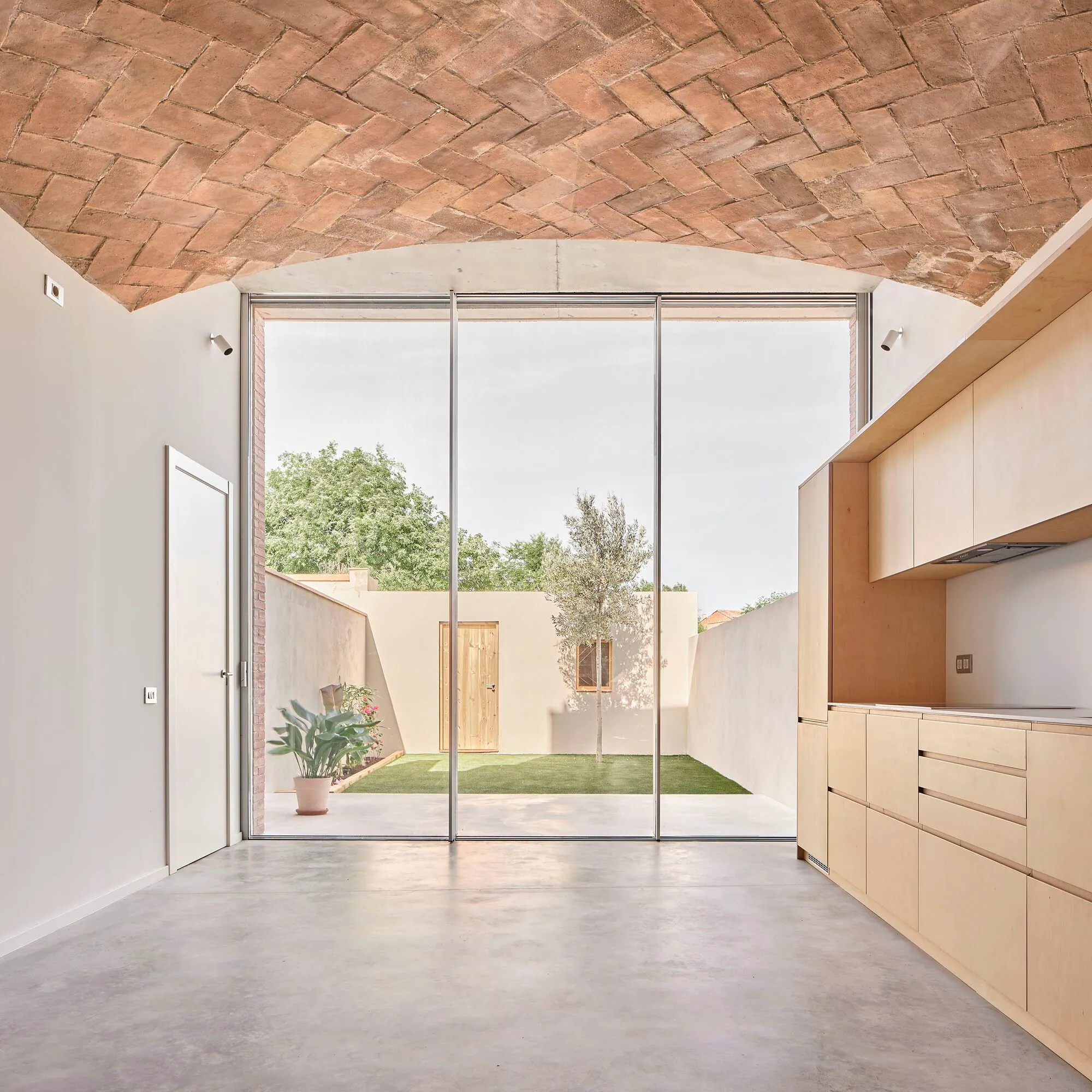Pineda Monedero Hollows Out a 1900 Sabadell Row House and Lets the Courtyard Back In